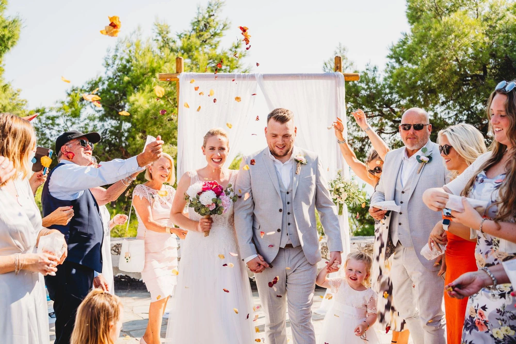 Couple walking out of wedding ceremony being photographed by Pixography Wedding Co